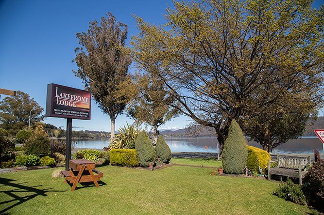 Signage at front of Lakefront Lodge with Lake Te Anau in the background